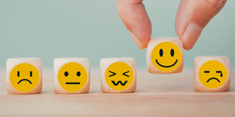 5 Würfel mit Smiley-Motiven zum Thema Sentimentanalyse